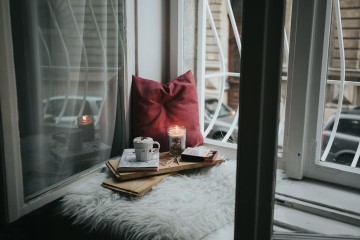 Cozy Winter - photo of gel candle on board beside pillow