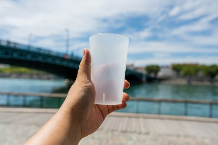 Reusable Products - a hand holding a white cup