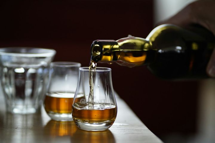 Irish Whiskey - photo of person holding glass bottle