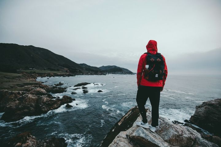 Pack - man standing on gray and black rock formation