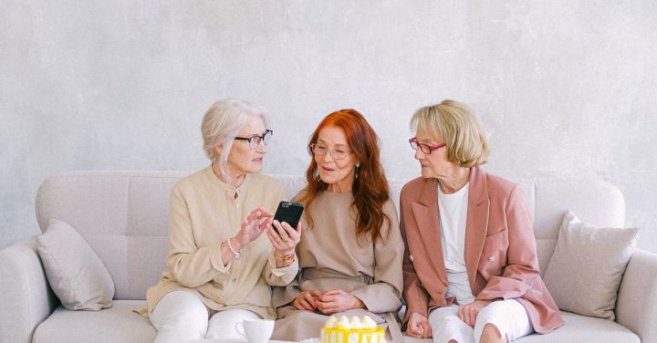 Tech - Women Sitting on Grey Sofa