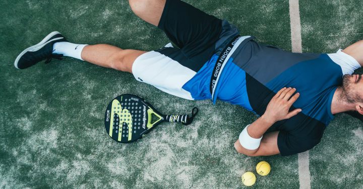 Sportswear - Man Lying Beside on Green Tennis Balls