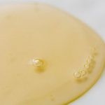 Beauty Essentials - Transparent yellowish liquid on white surface