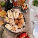 Foodie Favorites - Person in Blue T-shirt Sitting on Chair in Front of Table With Foods