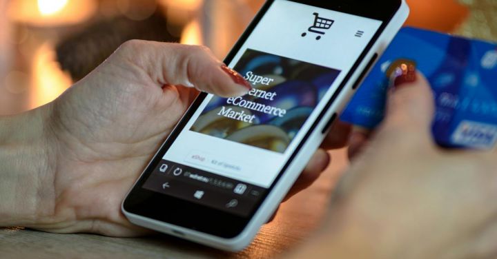 Shopping - Person Using Black And White Smartphone and Holding Blue Card