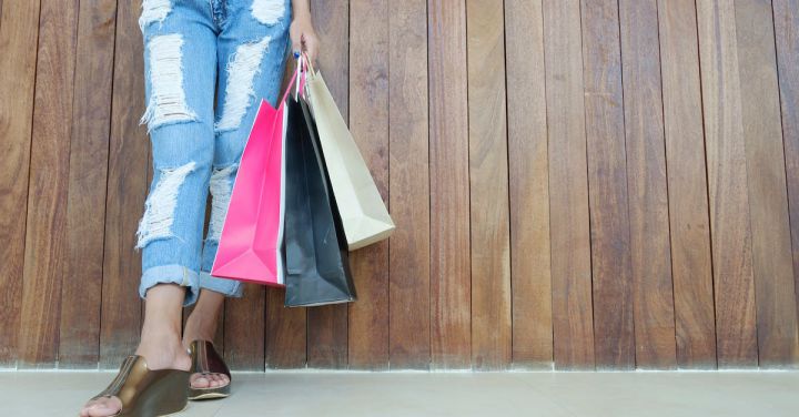 Shopping - Woman Wearing Distressed Jeans